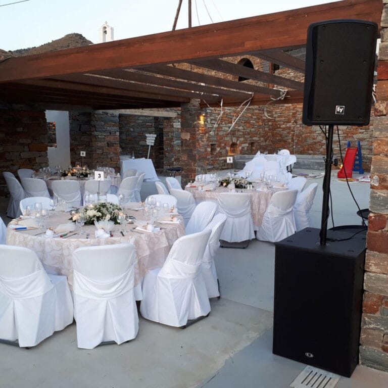 Wedding reception setup with professional sound system and elegant table arrangement